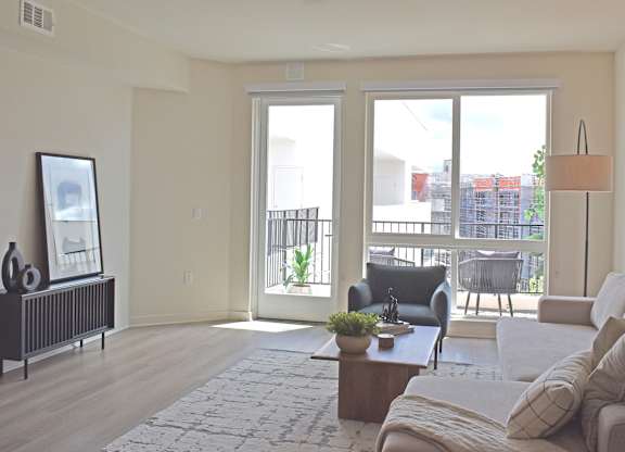 Bright living area with balcony views at Garden at 3Roots Apartments, California, 92126