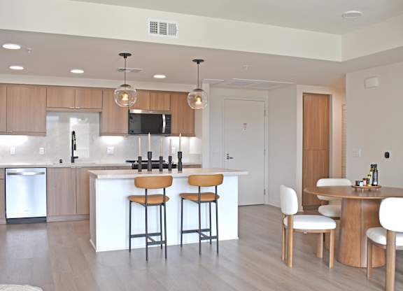 Open concept kitchen and dining area at Garden at 3Roots Apartments, San Diego, CA 92126