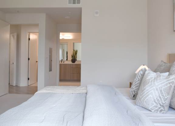 Spacious bedroom with ensuite bathroom at Garden at 3Roots Apartments, San Diego, California