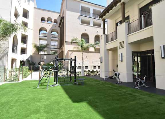 Outdoor fitness area with artificial turf courtyard at Casa Mira View Apartments, San Diego