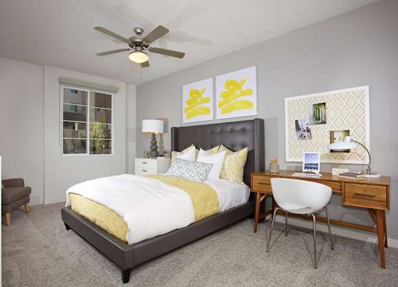 Bedroom with desk and yellow accent decor at Casa Mira View Apartments, California, 92126