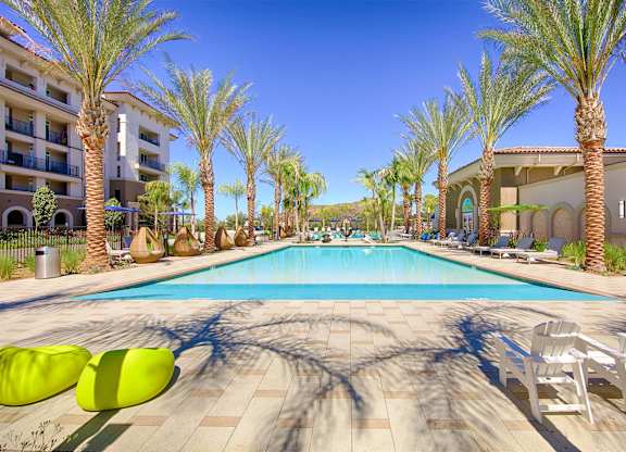 Rectangular pool with palm trees and cabanas at Casa Mira View Apartments, California, 92126
