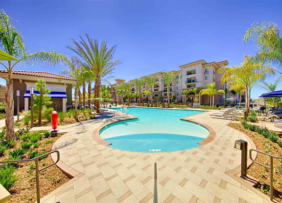 Resort style pool with cabanas and palm trees at Casa Mira View Apartments, San Diego, California