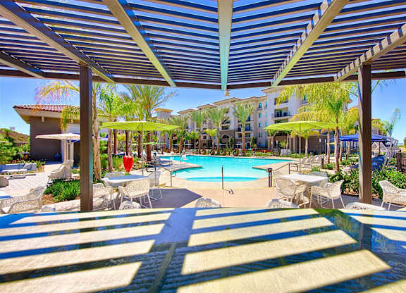 Pergola covered patio overlooking resort pool area at Casa Mira View Apartments, California
