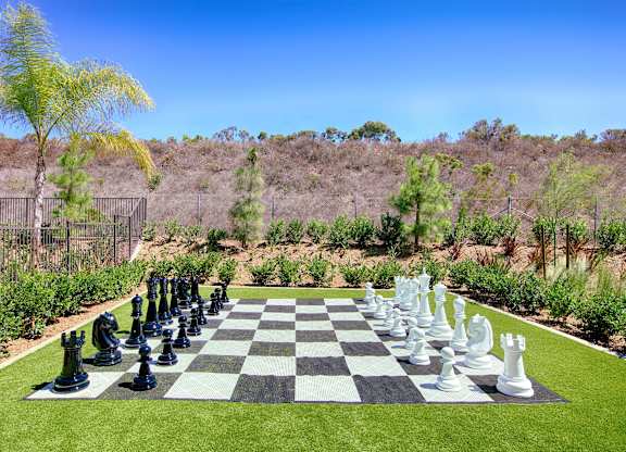 Oversized chess set on artificial turf lawn at Casa Mira View Apartments, San Diego