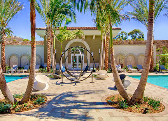 Courtyard with modern sculpture and arched architecture at Casa Mira View Apartments, California