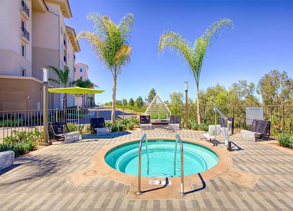 Circular spa with paver deck and palm trees at Casa Mira View Apartments, San Diego, 92126