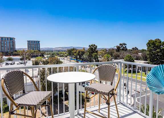 Private balcony with bistro table and chairs at Elements Apartments, Irvine, CA