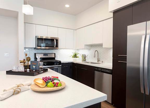Modern kitchen with two tone cabinetry and stainless appliances at Elements Apartments, Irvine, 92612