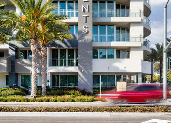 Modern apartment building exterior with vertical signage at Elements Apartments, Irvine, CA