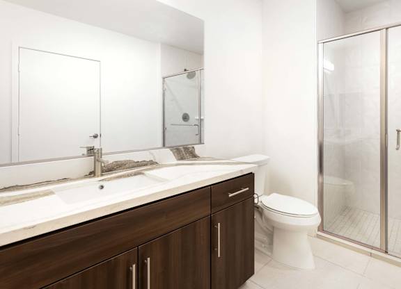 Bathroom with walk in shower and dual sink vanity at Elements Apartments, Irvine, CA