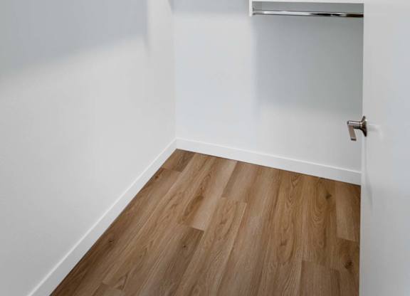 Walk-in closet with shelving and hanging rods at Elements Apartments, Irvine