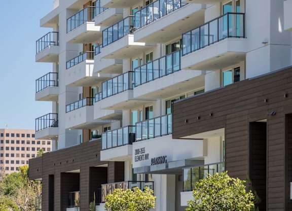 White modern building facade with cantilevered balconies at Elements Apartments, California