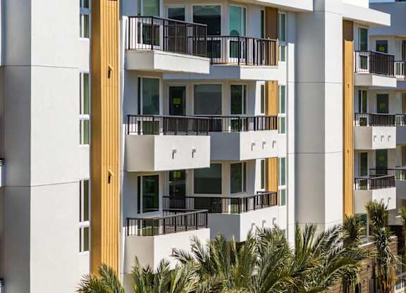 White residential building with vertical wood accents at Elements Apartments, Irvine, California