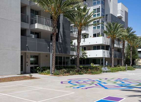 Outdoor courtyard with colorful painted game squares at Elements Apartments, Irvine, California