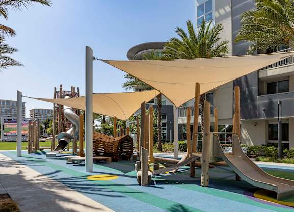 Playground with slides and shade sails at Elements Apartments, California