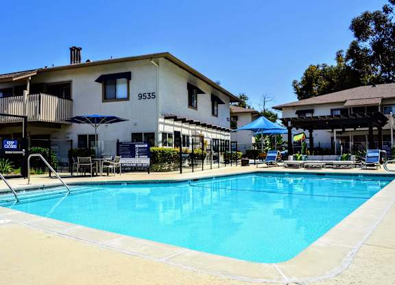 A swimming pool in front of a building at La Jolla Canyon Apartments, California