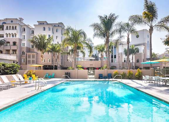 Resort style swimming pool with lounge chairs at La Jolla Crossroads Apartments, San Diego, CA