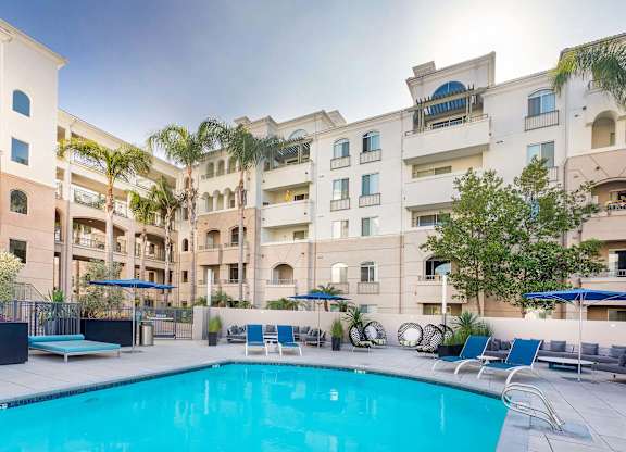 Swimming pool with sundeck and tropical landscaping at La Jolla Crossroads Apartments, California