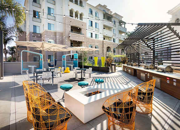 Outdoor rooftop lounge with fire pit and kitchen at La Jolla Crossroads Apartments, San Diego, CA 92122