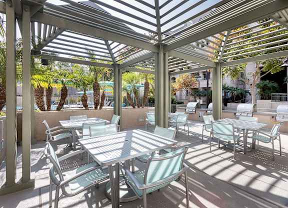 Covered patio dining area with pergola shade at La Jolla Crossroads Apartments, San Diego, CA 92122