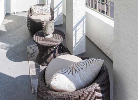 Private balcony with arched openings and seating at La Jolla Crossroads Apartments, San Diego