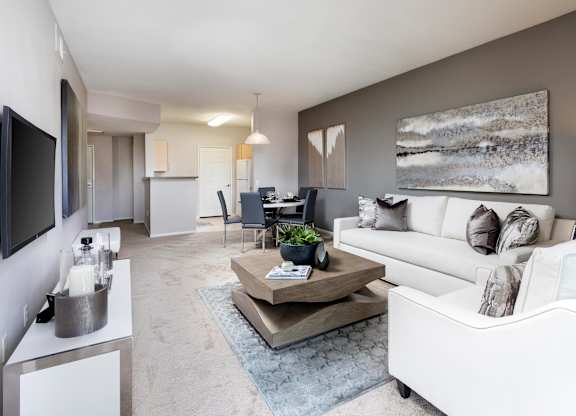 Open concept living room with white sectional sofa at La Jolla Crossroads Apartments, California, 92122