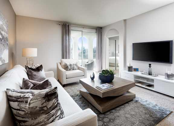 Living room with modern furniture and mounted tv at La Jolla Crossroads Apartments, San Diego, CA 92122