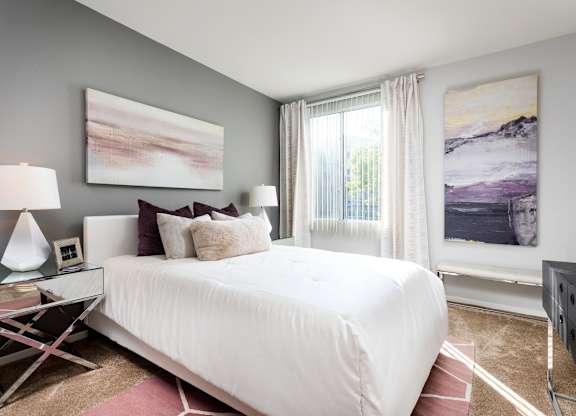 Contemporary bedroom with gray walls and white bedding at La Jolla Crossroads Apartments, San Diego, California