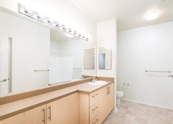 Spacious bathroom with dual sink vanity and lighting at La Jolla Crossroads Apartments, California