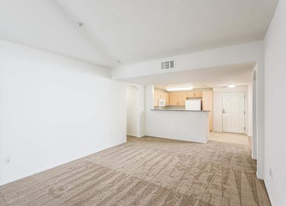 Open living space with carpeting and kitchen pass through at La Jolla Crossroads Apartments, San Diego, CA 92122
