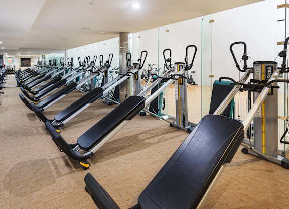 Fitness center with incline bench press equipment at La Jolla Crossroads Apartments, San Diego, California