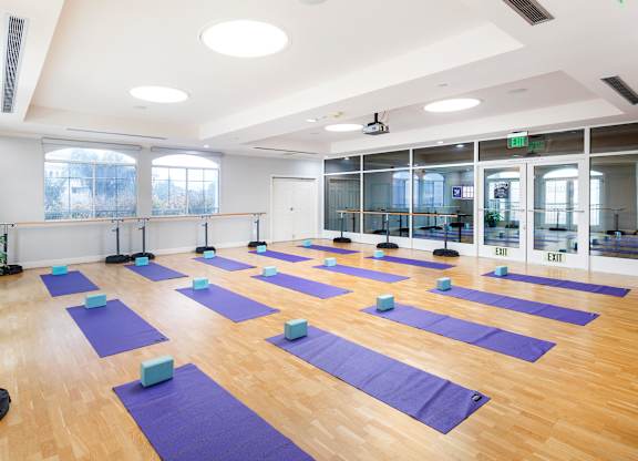 Yoga and barre studio with purple mats and blocks at La Jolla Crossroads Apartments, San Diego, California