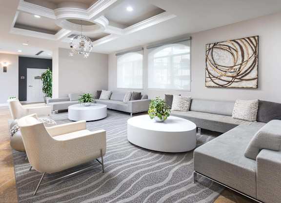 Modern community lounge with sectional seating and coffered ceiling at La Jolla Crossroads Apartments, San Diego, CA 92122