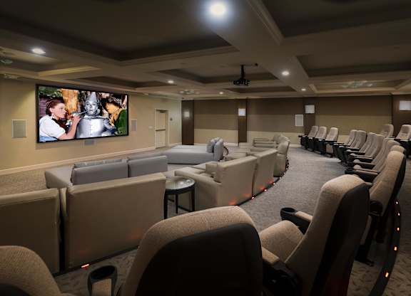 Private movie theater with tiered seating and projector screen at La Jolla Crossroads Apartments, San Diego, 92122