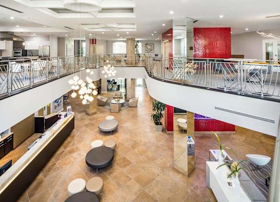 Two story lobby with modern seating and decorative lighting at La Jolla Crossroads Apartments, San Diego