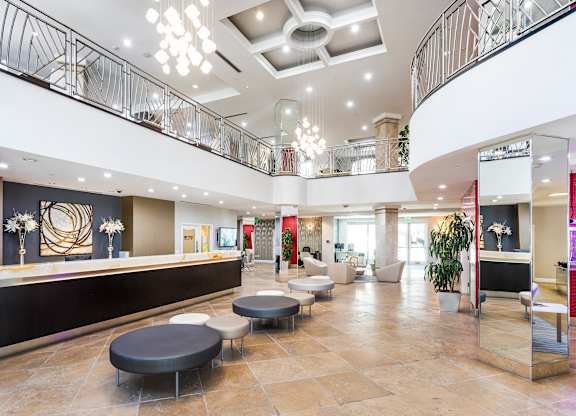 Grand two story lobby with chandelier and balcony overlook at La Jolla Crossroads Apartments, San Diego, 92122