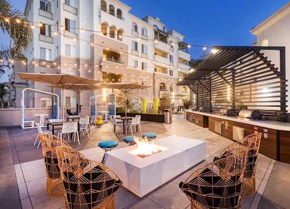 Rooftop terrace with fire pit and lounge seating at La Jolla Crossroads Apartments, San Diego