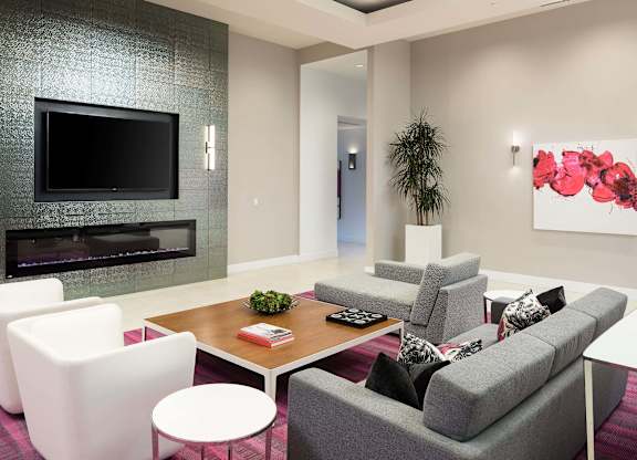 Community lounge with fireplace and flat screen tv at Metropolis Apartments, IRVINE, 92614