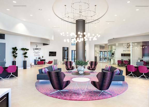 Elegant lobby with modern chandelier and stylish seating at Metropolis Apartments, IRVINE