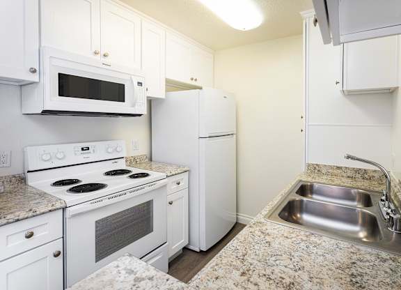 A Kitchen with White Appliances at Northridge Gardens Apartments, Northridge, CA, 91325