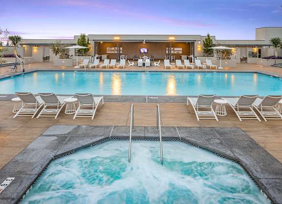 Swimming pool with spa and covered cabana seating at Casa Mira View Apartments, California