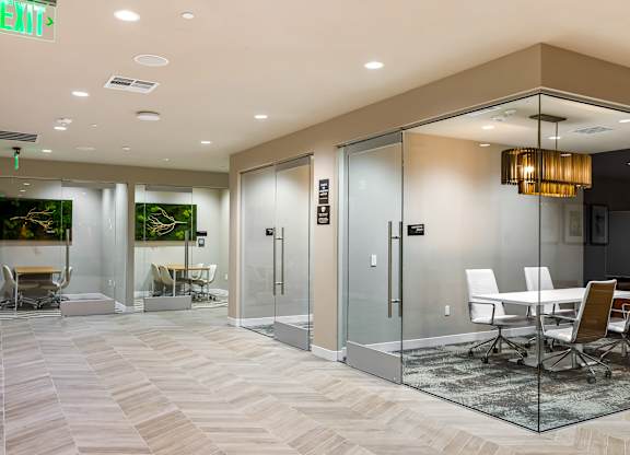 Glass walled conference rooms with herringbone flooring at Elements Apartments, Irvine, California