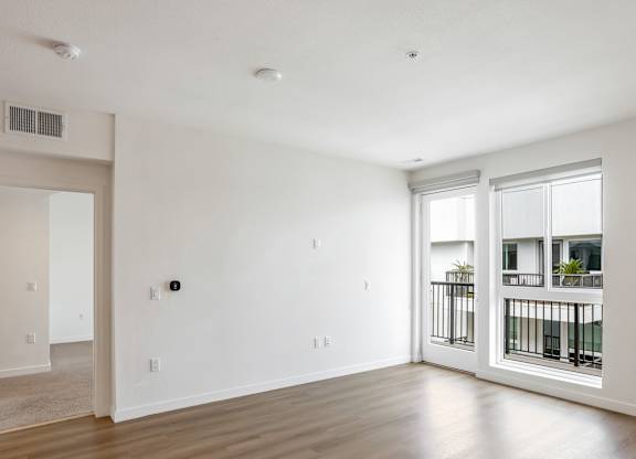 Bright living space with hardwood flooring and windows at Elements Apartments, Irvine, 92612