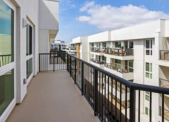 Private balcony with black railing and courtyard views at Elements Apartments, Irvine, CA