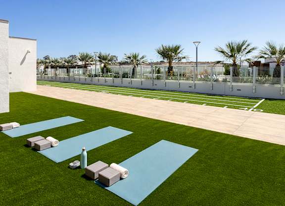 A lawn area with a designated space for yoga.