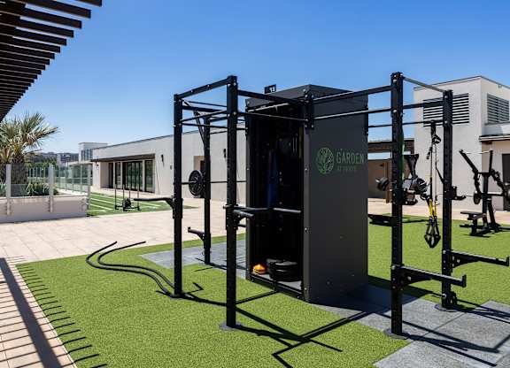 An outdoor fitness area with weightlifting equipment.