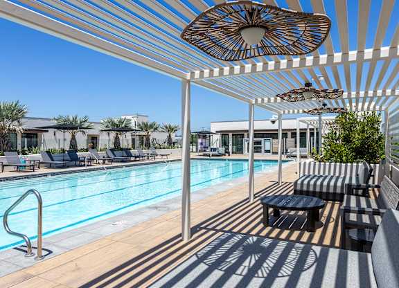 Poolside cabanas with lounge seating.