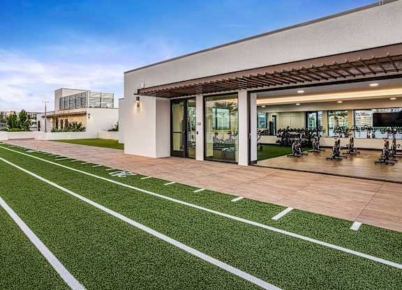 An outdoor fitness area featuring a 40-yard dash and stationary bikes.