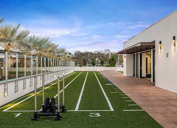 An outdoor fitness area with a 40-yard dash and weights.